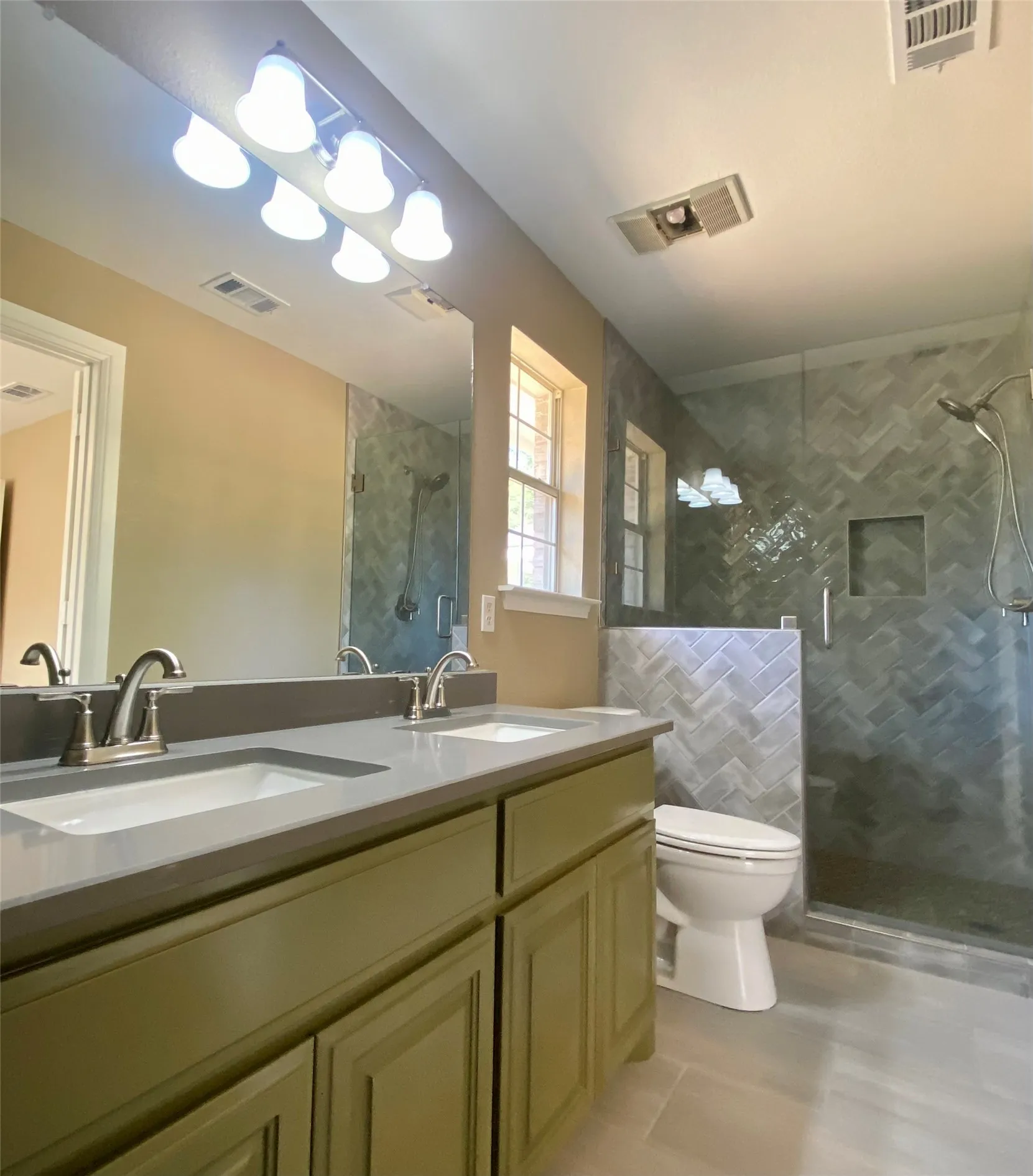 Dual vanity with light-toned countertop, brushed nickel fixtures, and ample cabinetry