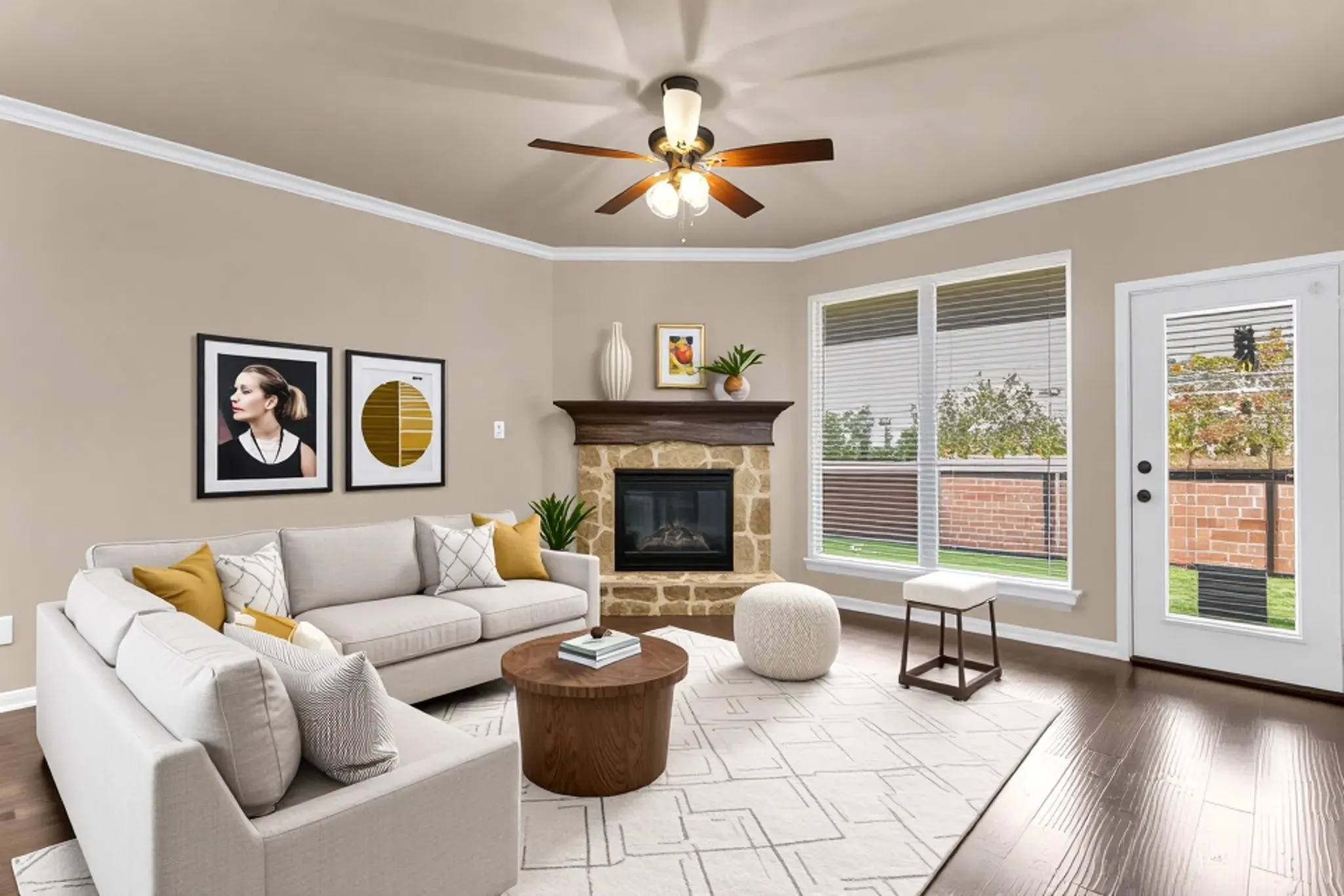 Living area featuring a stone fireplace with a wood mantle, rich wood-finish flooring, and crown molding