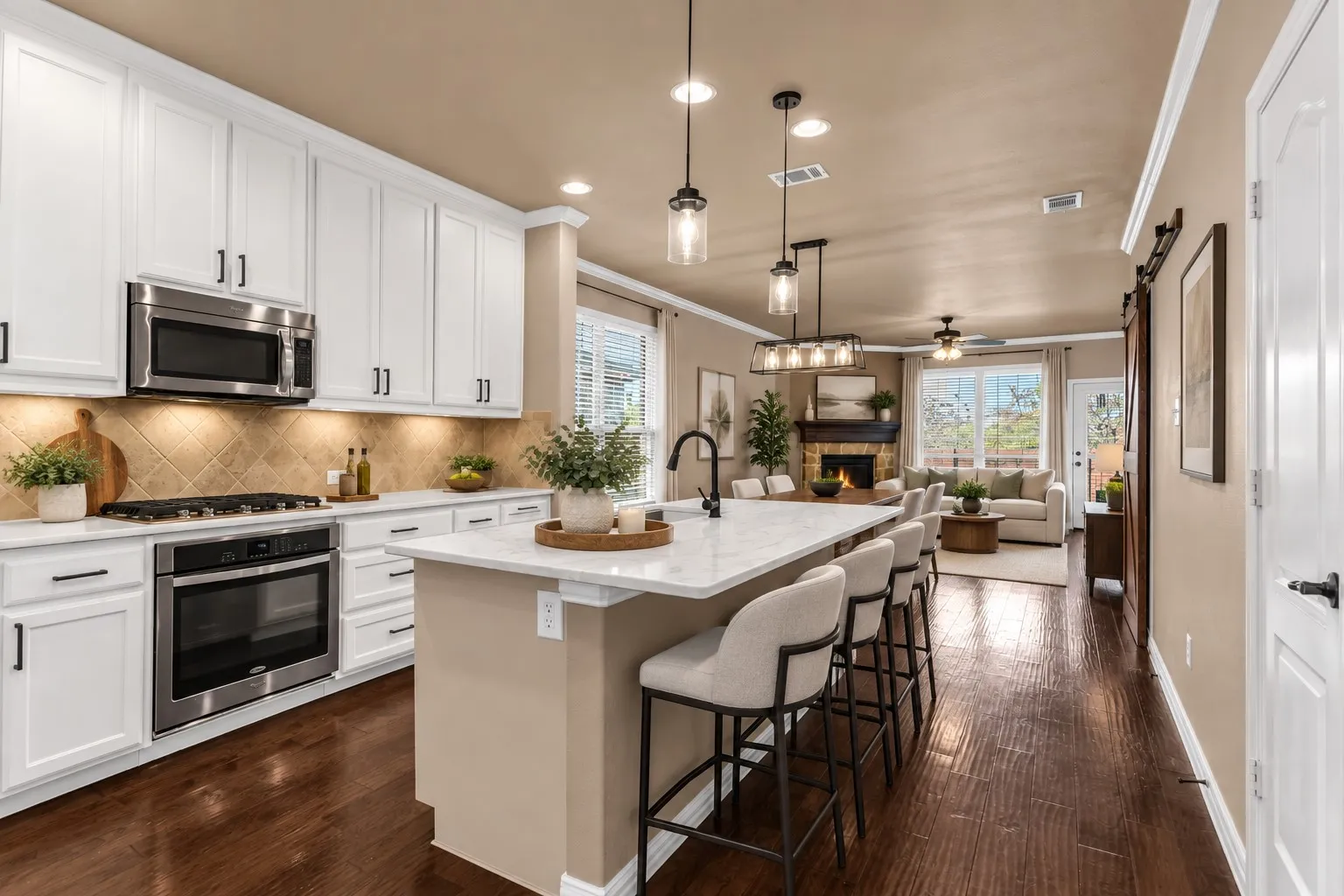 White shaker cabinetry with black hardware, stainless steel appliances, patterned tile backsplash, center island with an undermount sink and pendant lighting, and wood-finish flooring