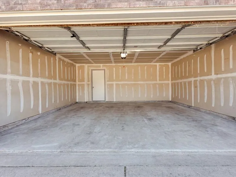 AI cleaned - the water heater is in the garage on the left side.