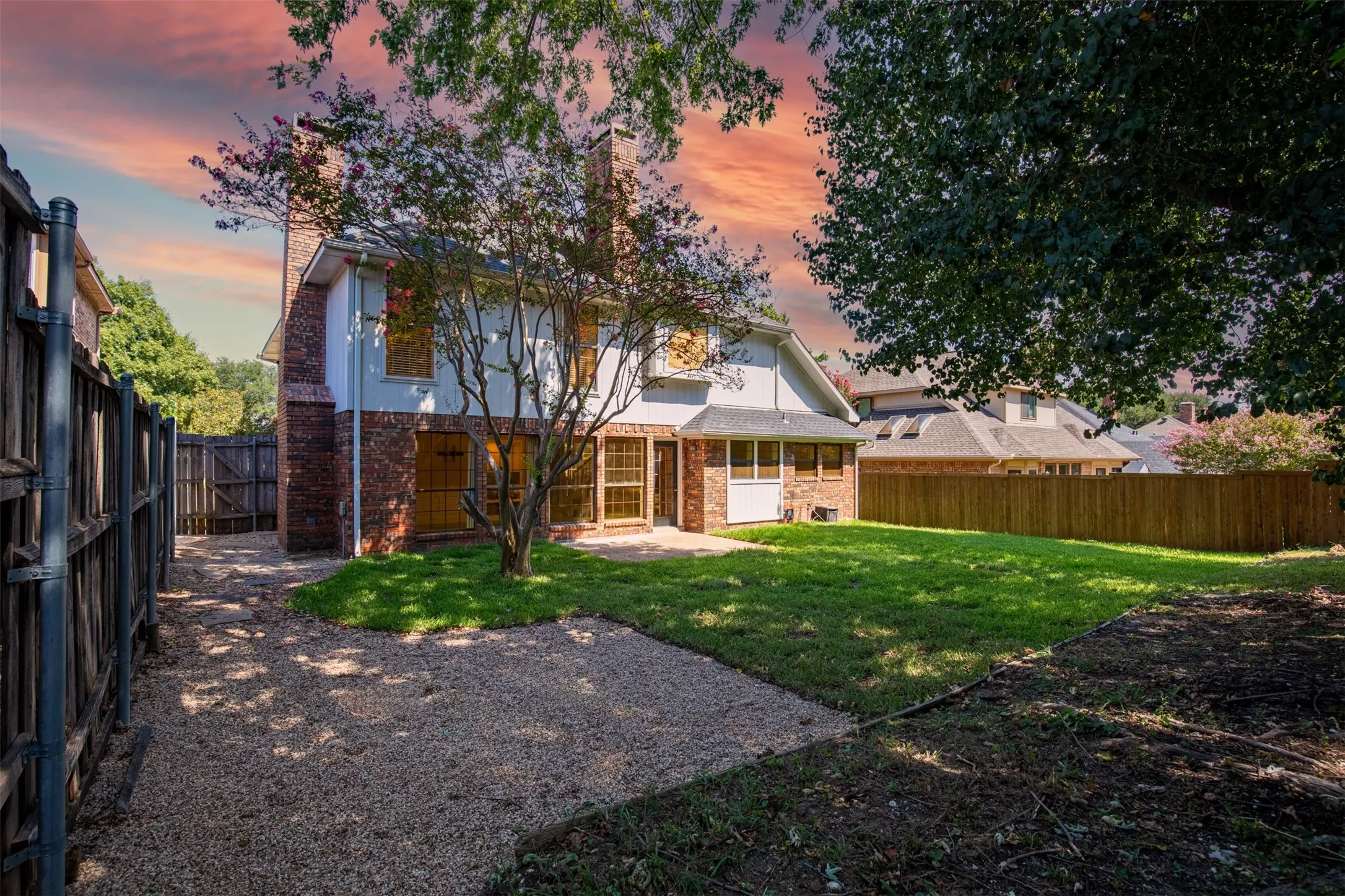 Backyard with patio and grassy yard.