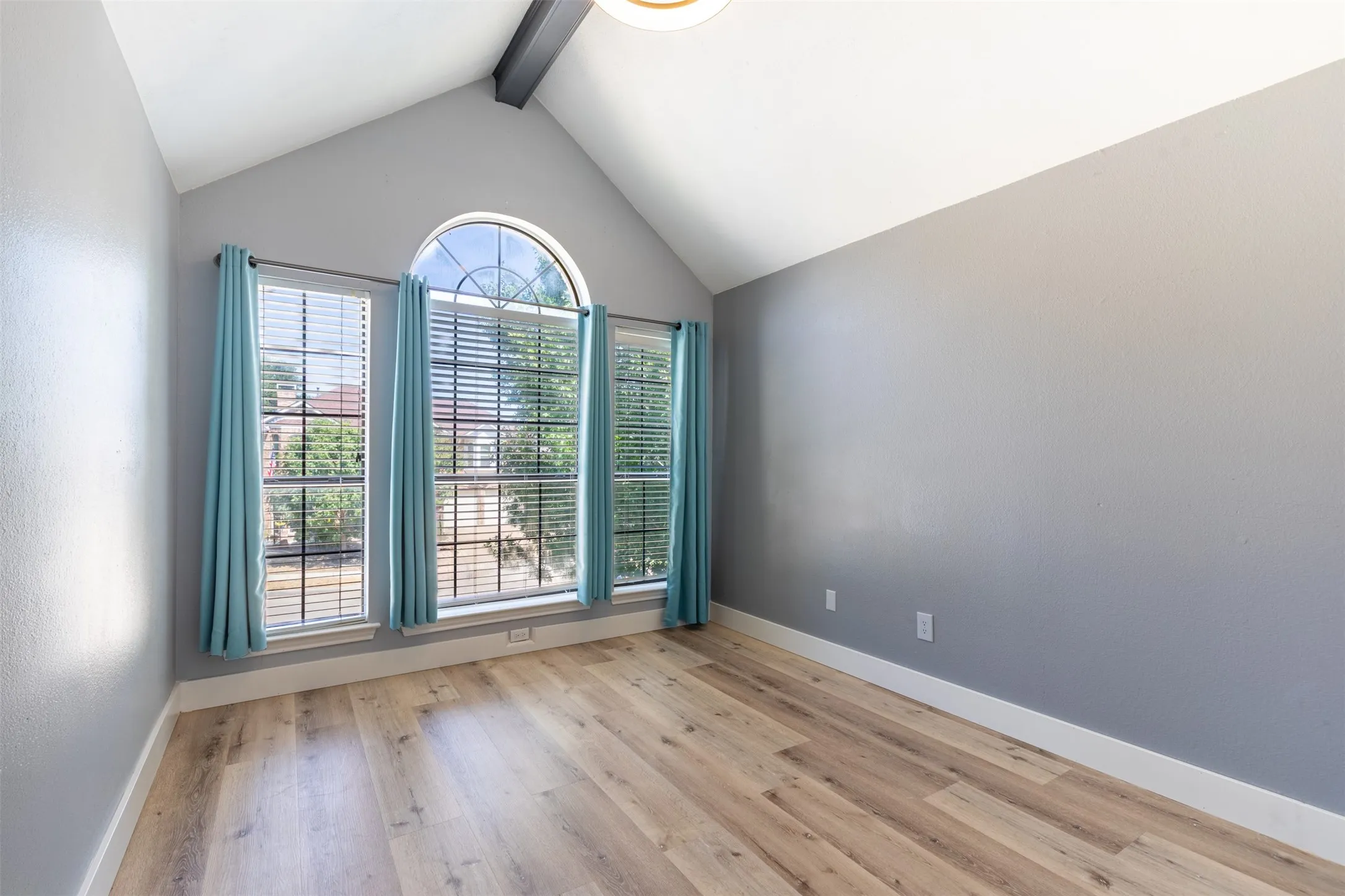 Upstairs secondary bedroom with vaulted ceiling.
