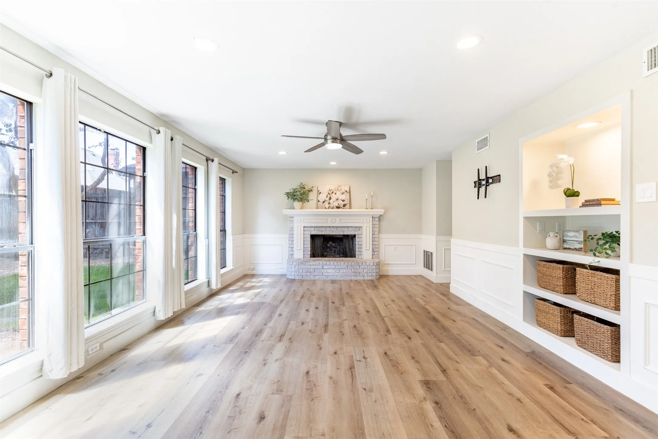Family room anchored by a cozy fireplace with mantel.
