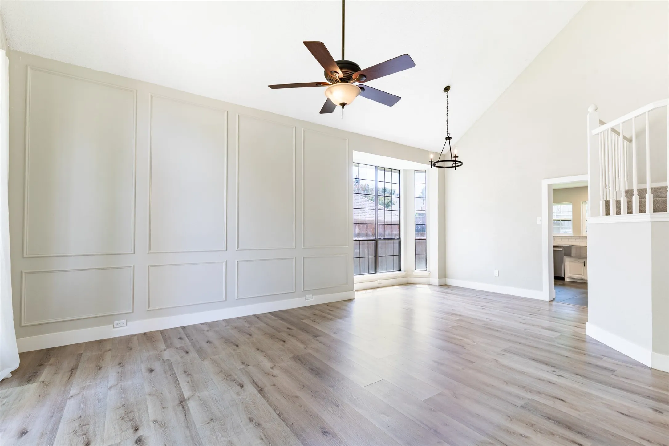 Living room flows effortlessly into the dining room with vaulted ceiling.