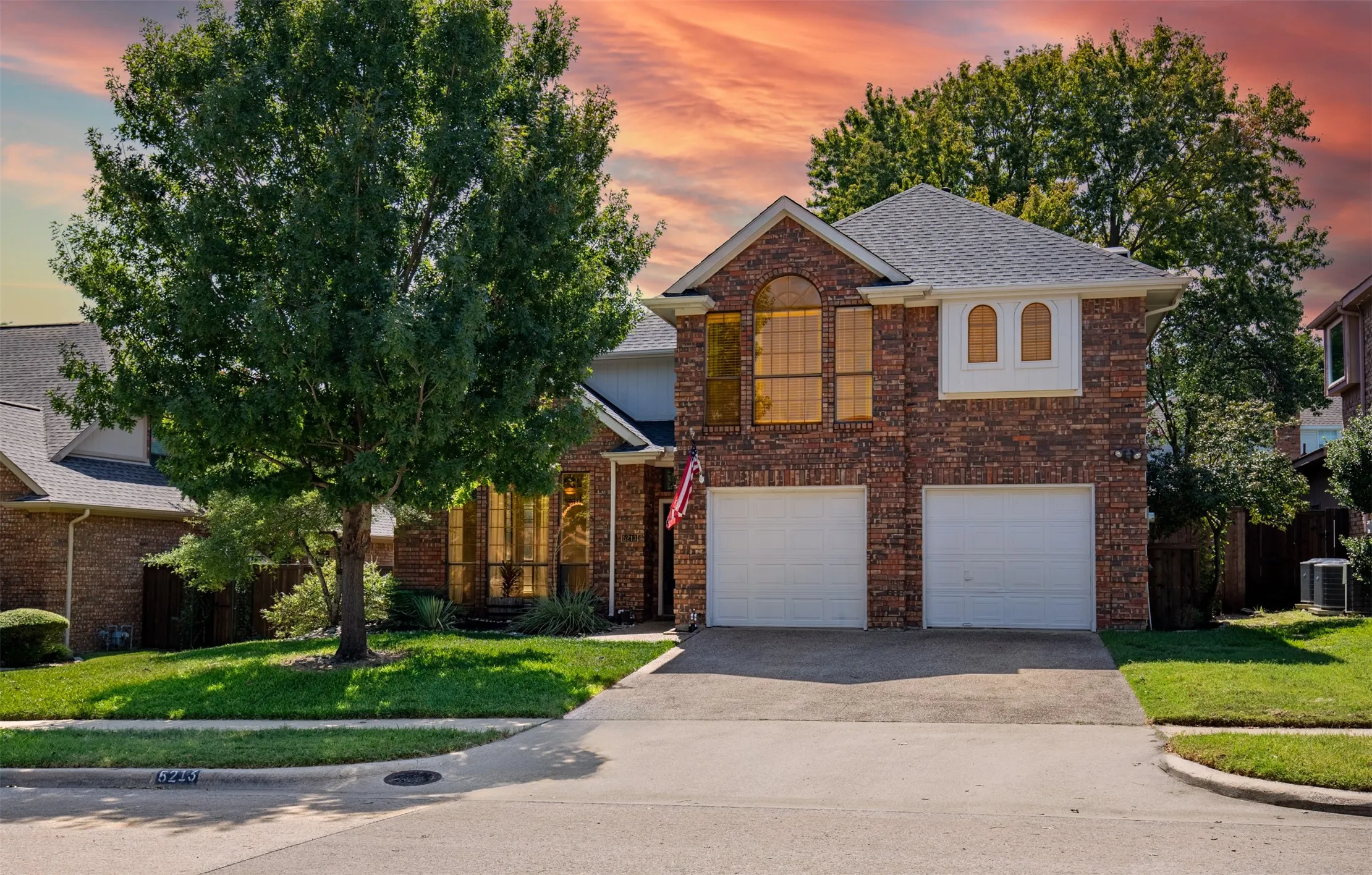 Beautiful curb appeal with shaded trea and front-entry garage.
