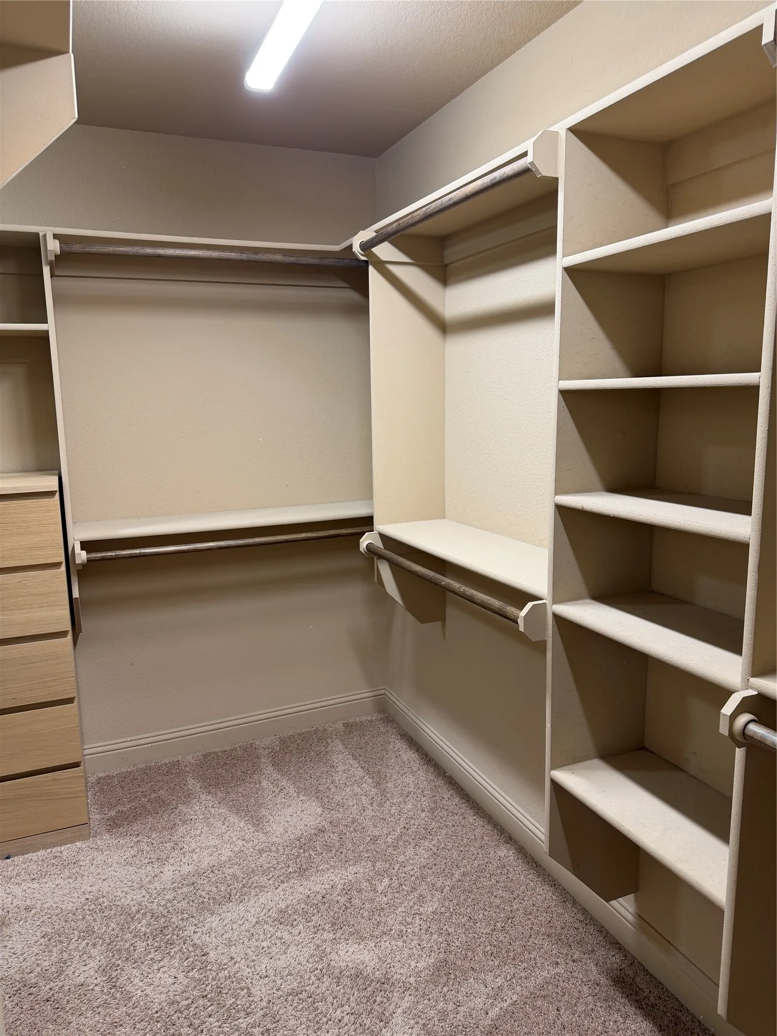Built-in closet system featuring shelving, hanging rods, and integrated drawers