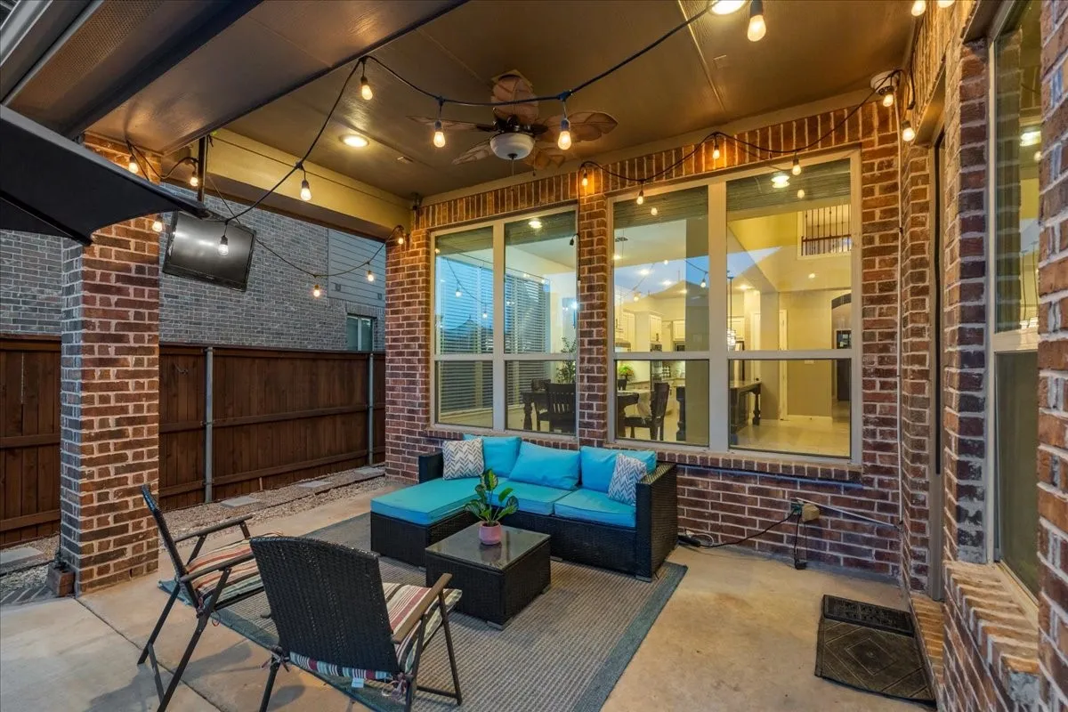 Covered patio with additional lighting and TV.