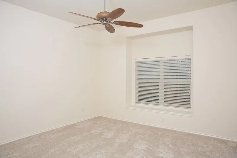 The master bedroom is very large and has high ceilings.