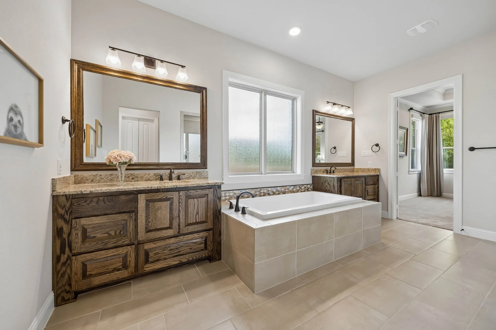 Separate vanities, extremely large, luxury bathtub.