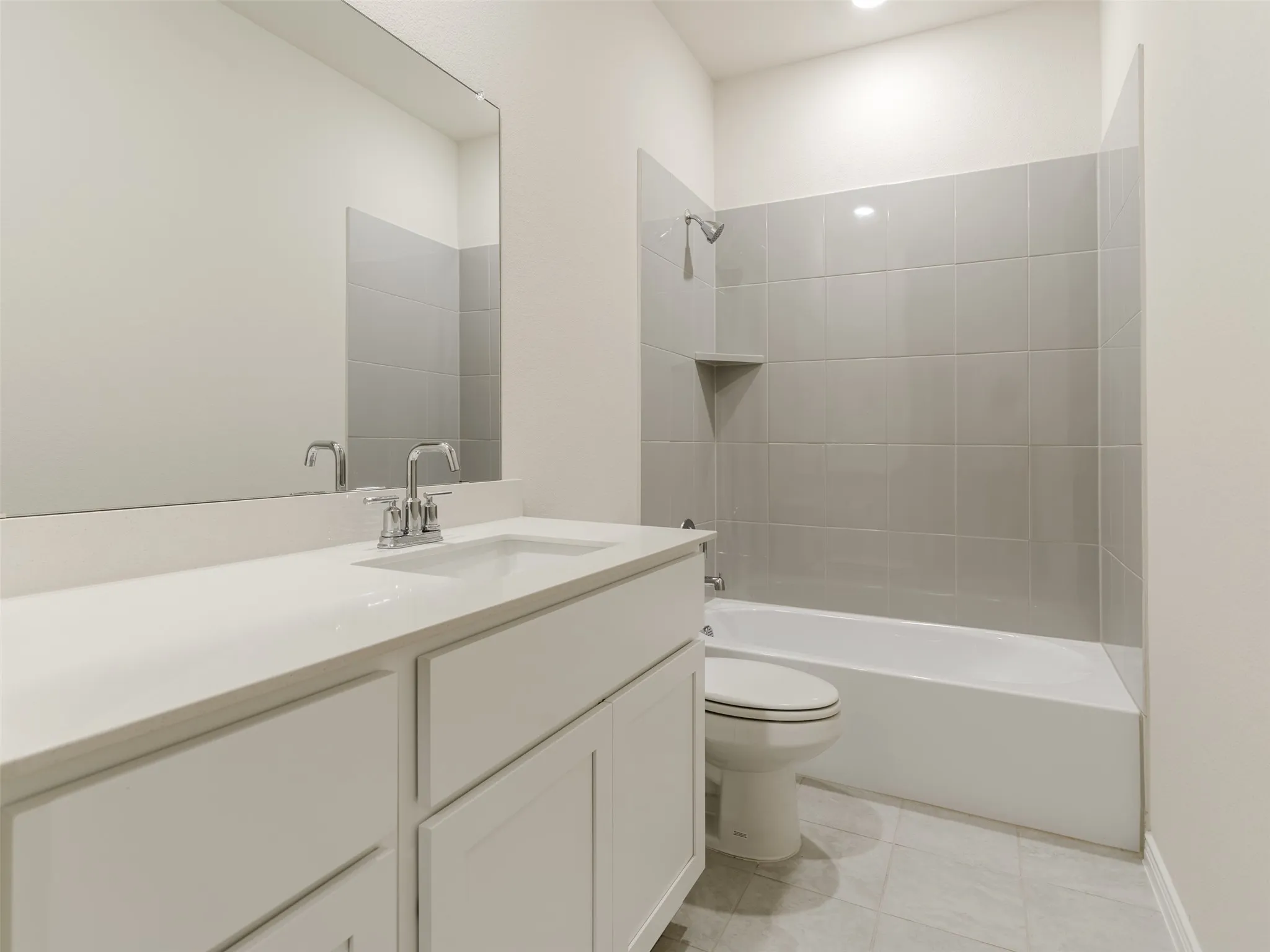 White vanity with an integrated sink, polished chrome faucet, and a wall-mounted mirror