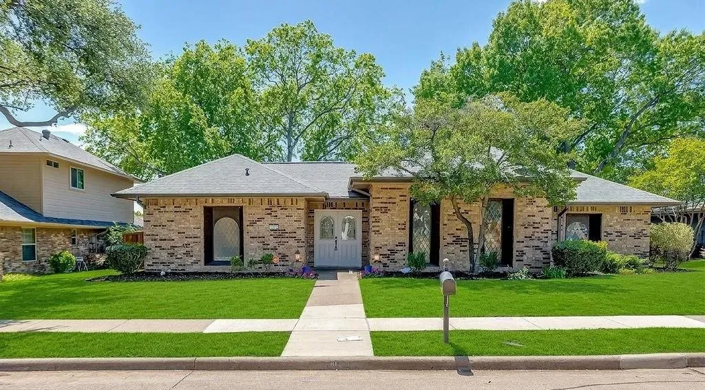 Brick exterior with a gray shingle roof