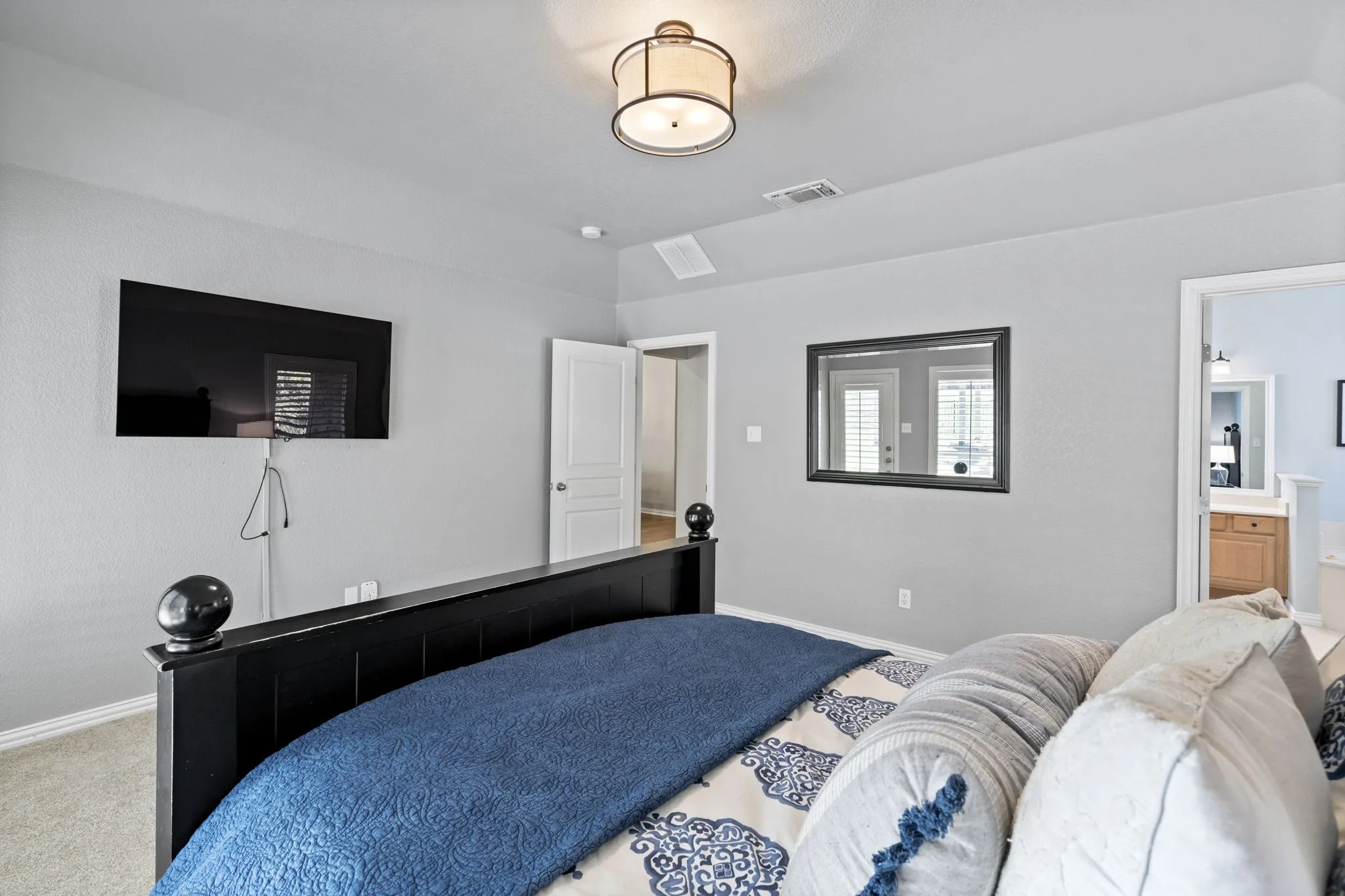 Recessed ceiling light fixture, wall-mounted television, and neutral wall paint