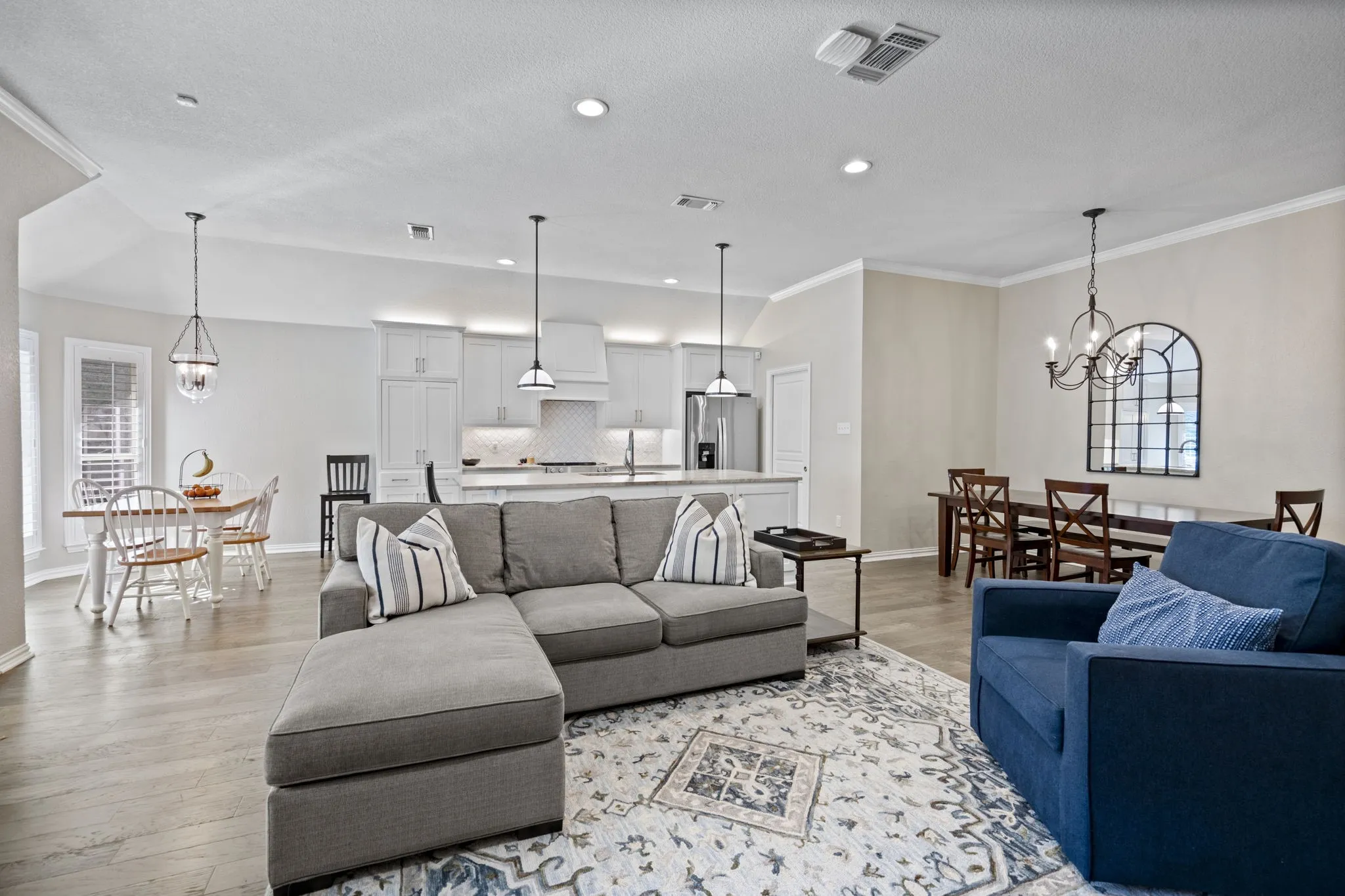 Open-concept living area featuring wood-finish flooring and recessed lighting