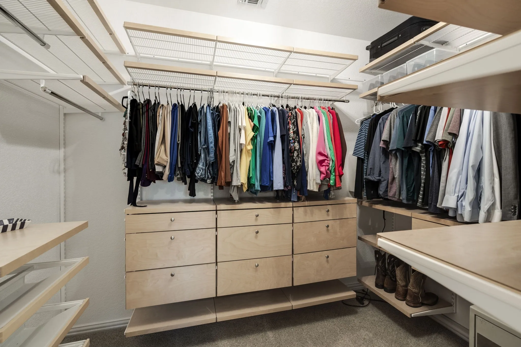 Customizable closet system with wood-finish shelving, built-in drawer storage, and ample hanging space