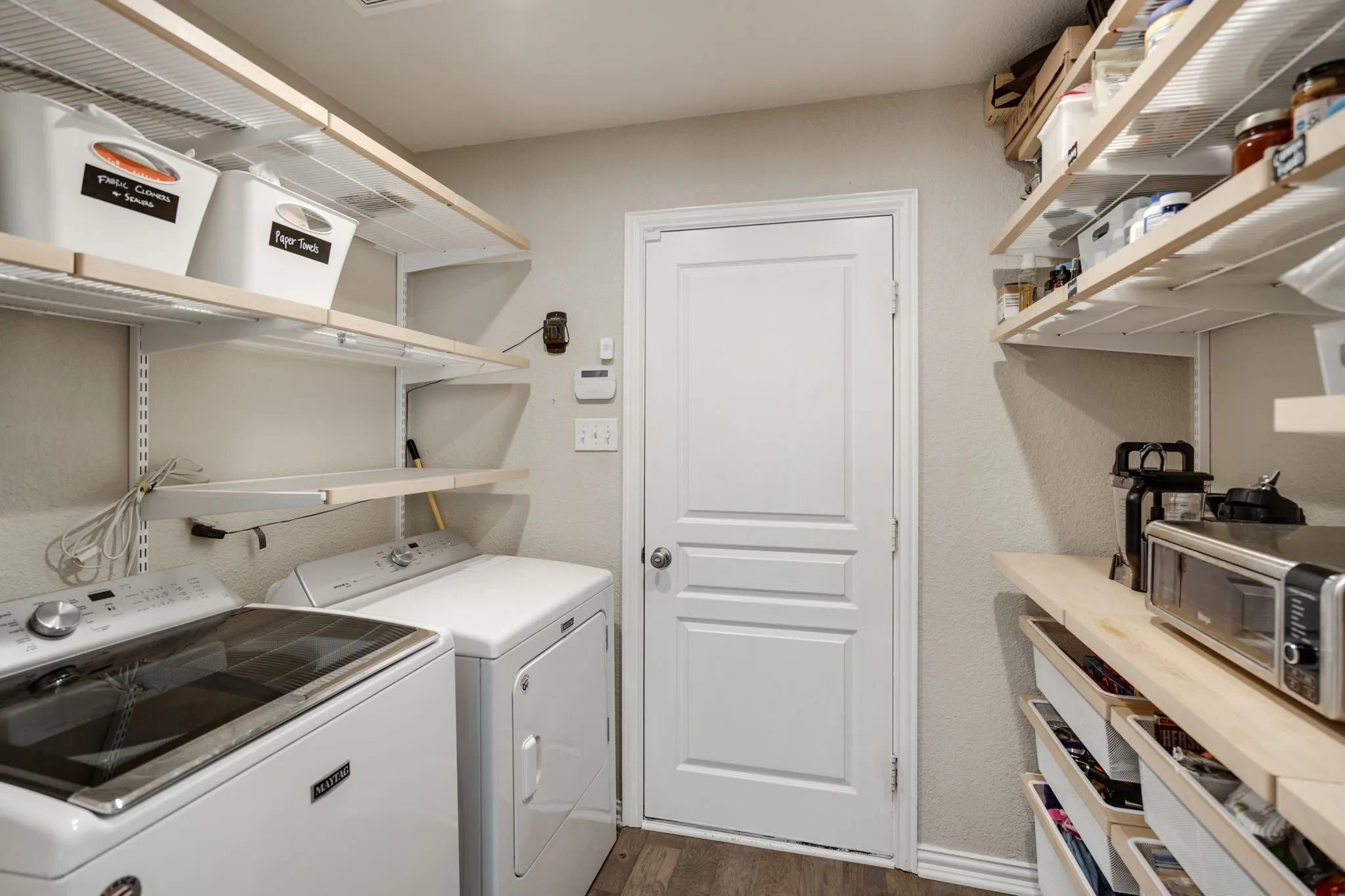 Laundry area featuring a top-load washing machine and front-load dryer