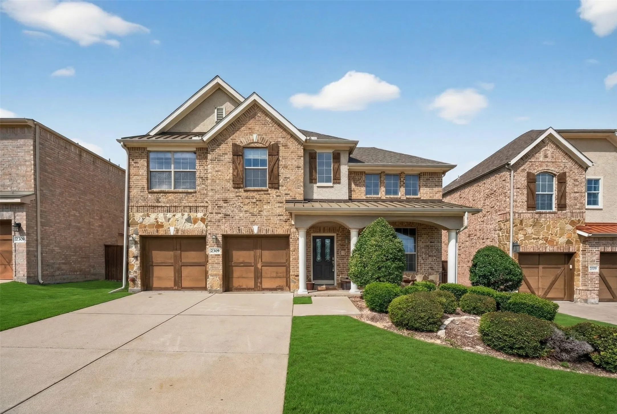 Brick and stone exterior with decorative window shutters