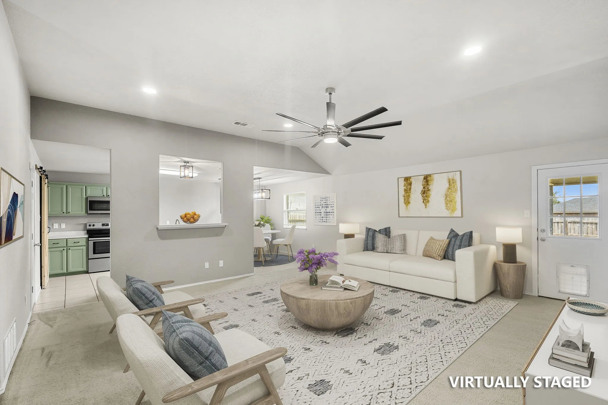 Vaulted ceiling with a contemporary ceiling fan, recessed lighting, and a pass-through window