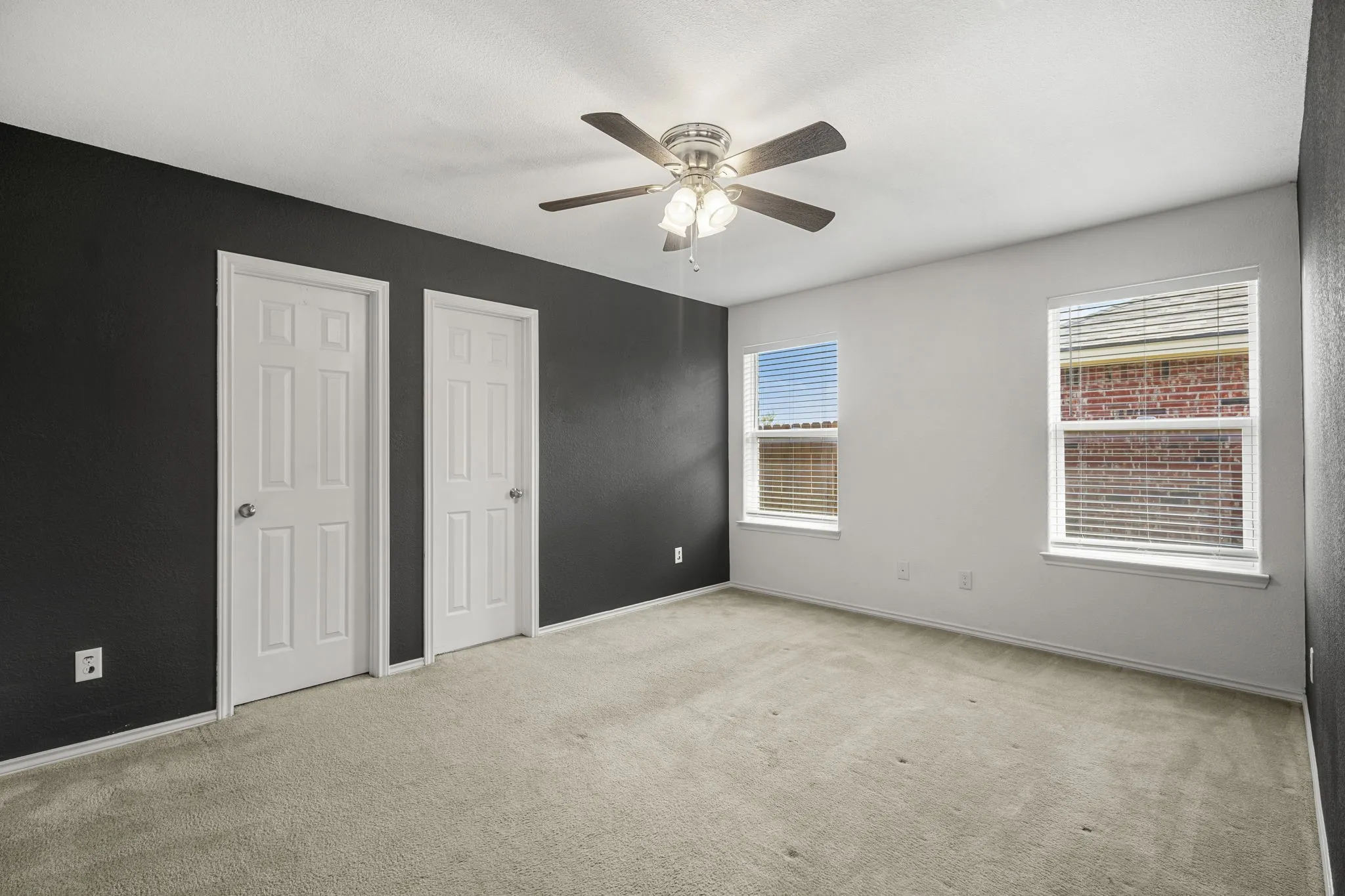 Neutral-toned carpeting complements the white and dark-painted walls