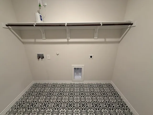 Patterned floor tiling, wall-mounted shelving, and hanging rod