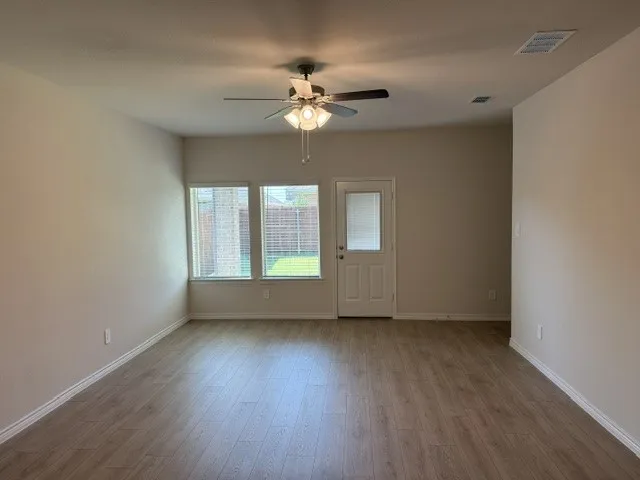 Wood-finish flooring throughout, paired with light-toned walls