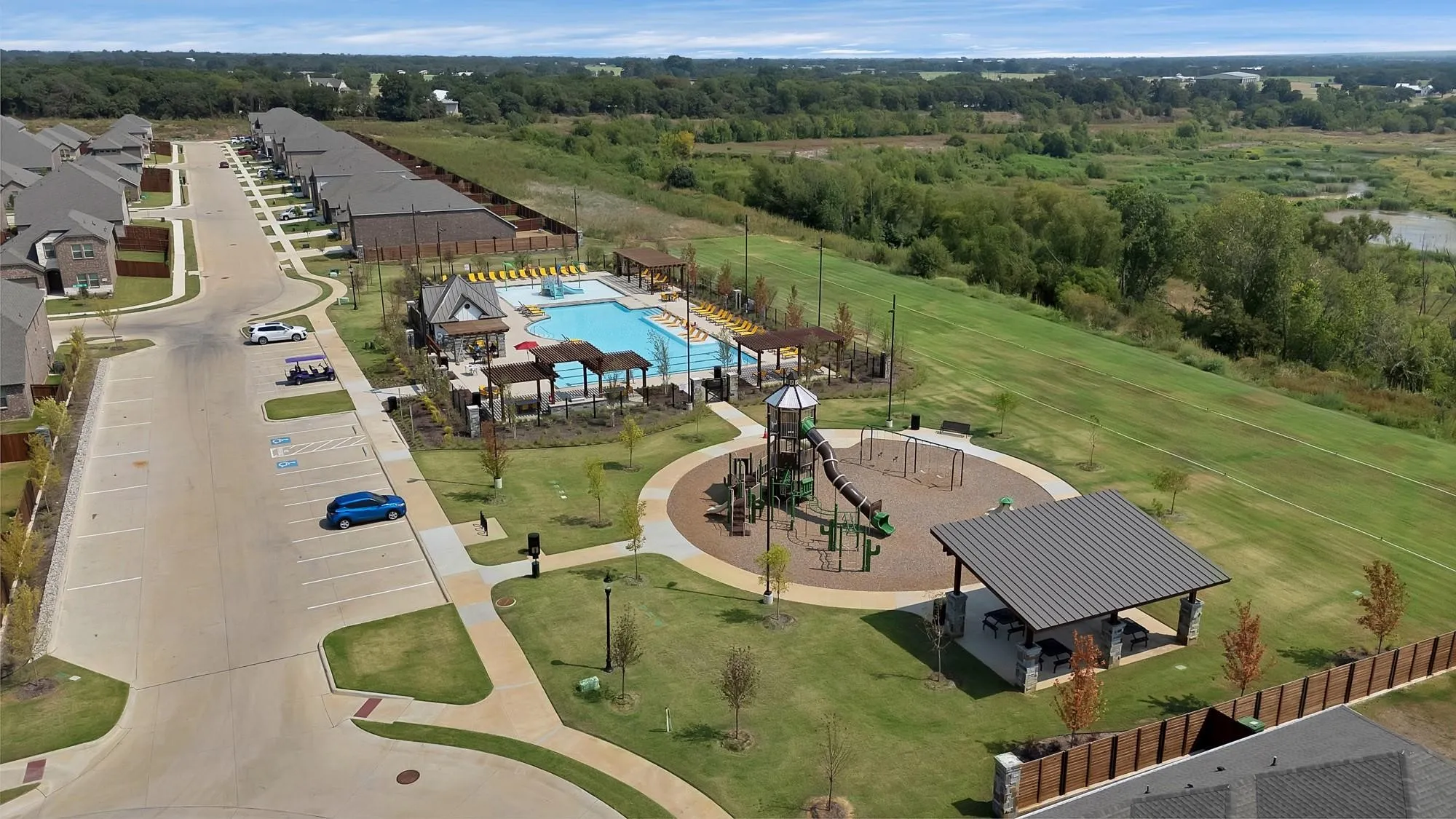 Community amenities featuring a swimming pool, covered lounge areas, a playground, and a covered picnic area