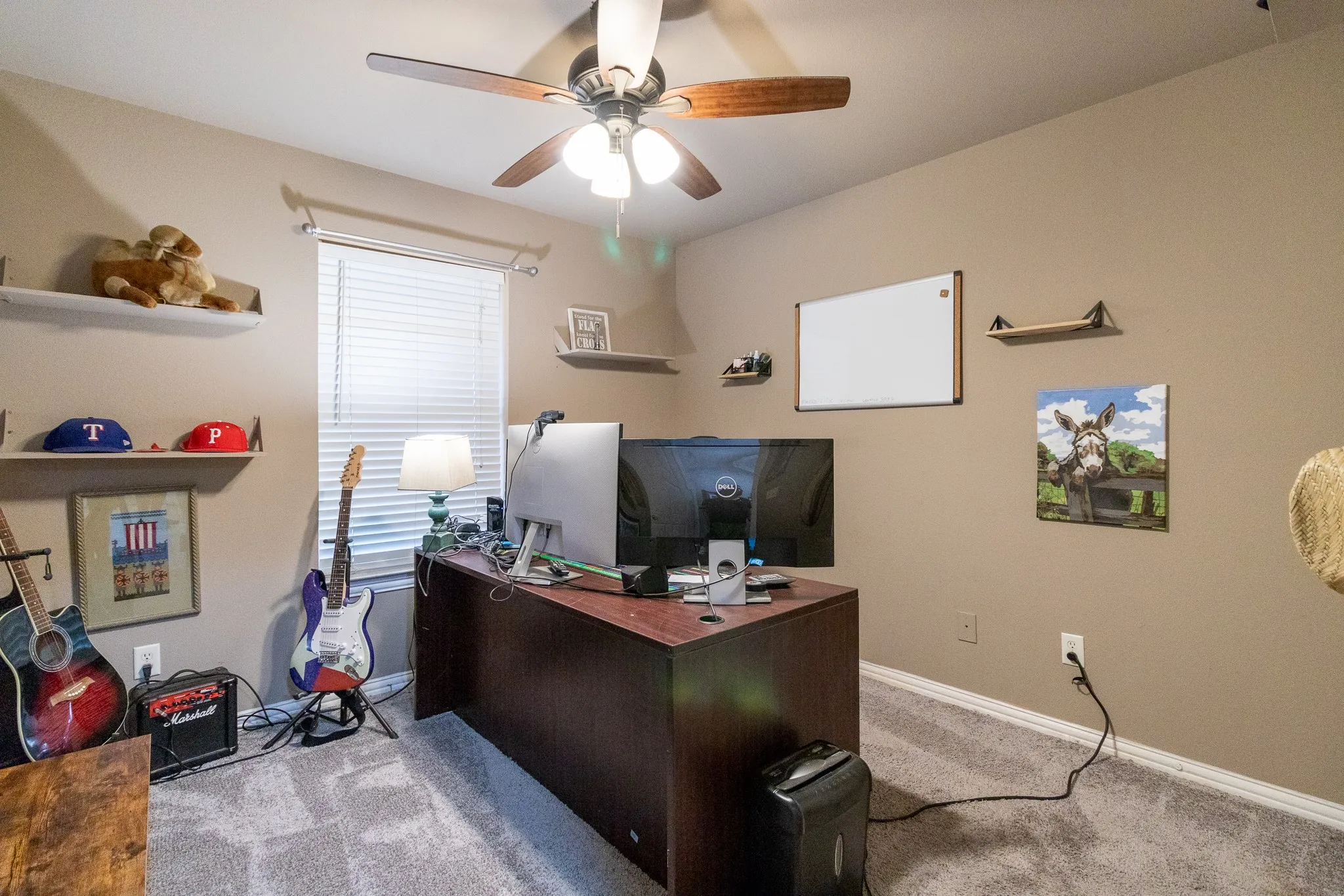 Wall-to-wall carpeting and a ceiling fan with integrated lighting