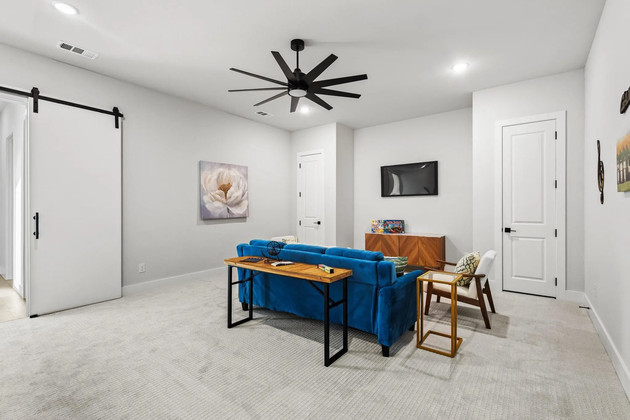 Media Room/4th Bedroom with a barn door, light colored carpet, recessed lighting, and ceiling fan