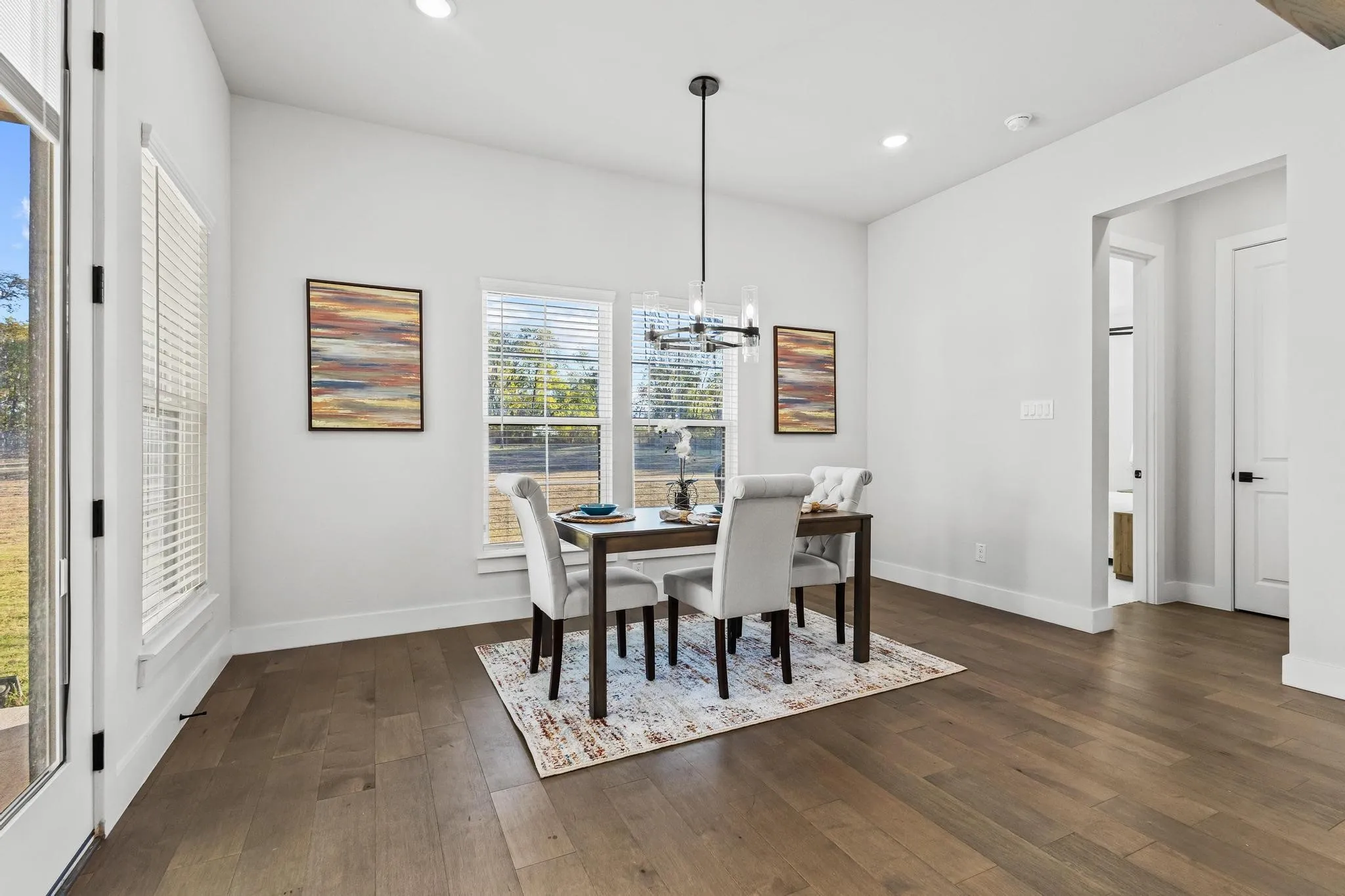 Dining room featuring a chandelier, recessed lighting, and dark wood finished floors