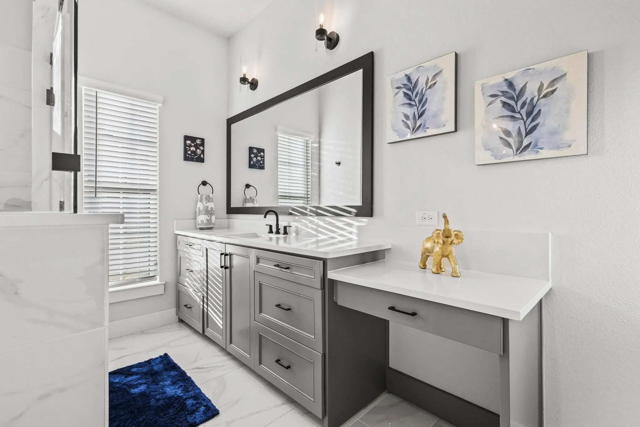 Bathroom featuring vanity and light marble finish floors