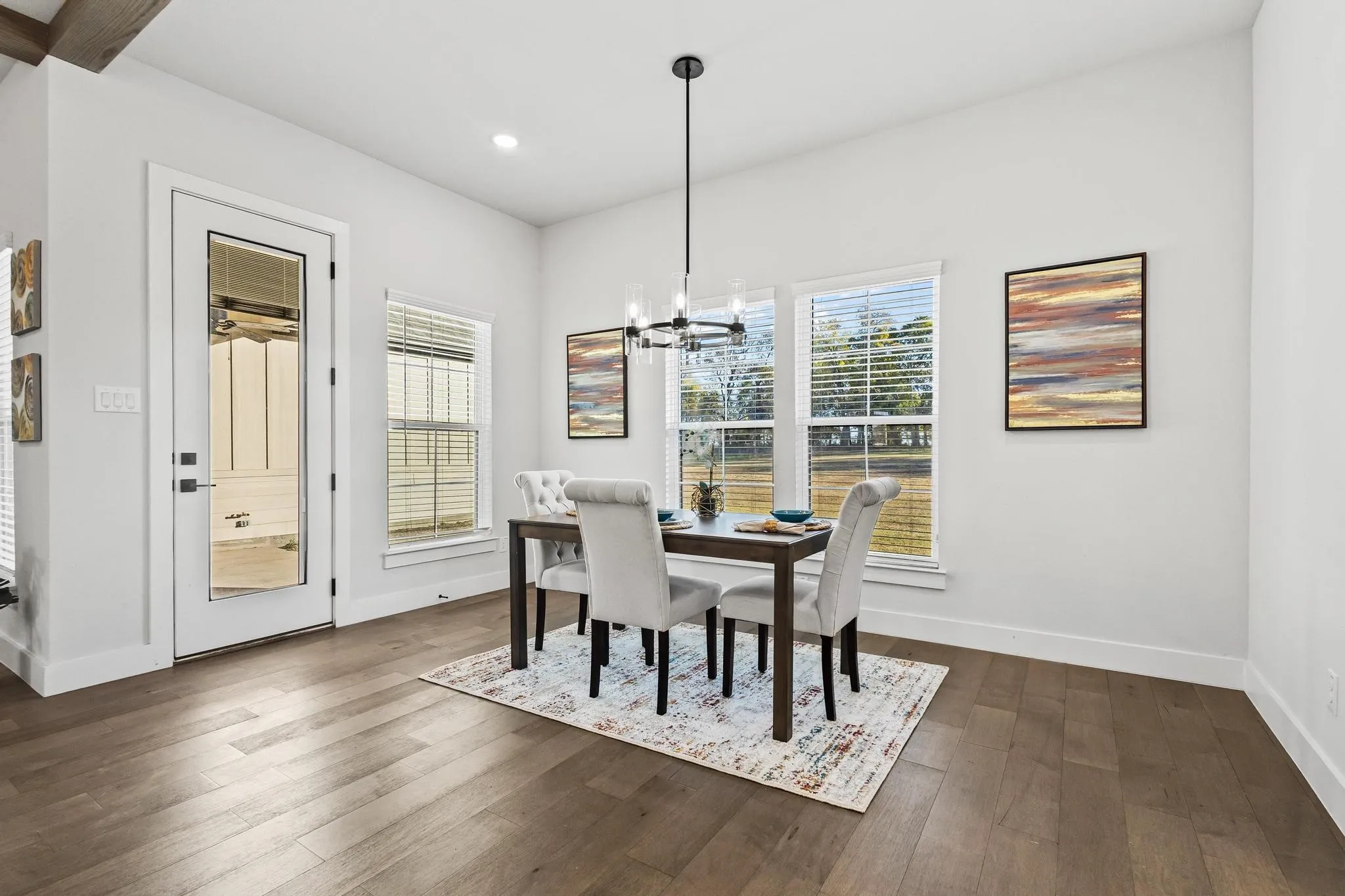 Dining area with a chandelier, dark wood finished floors, and recessed lighting
