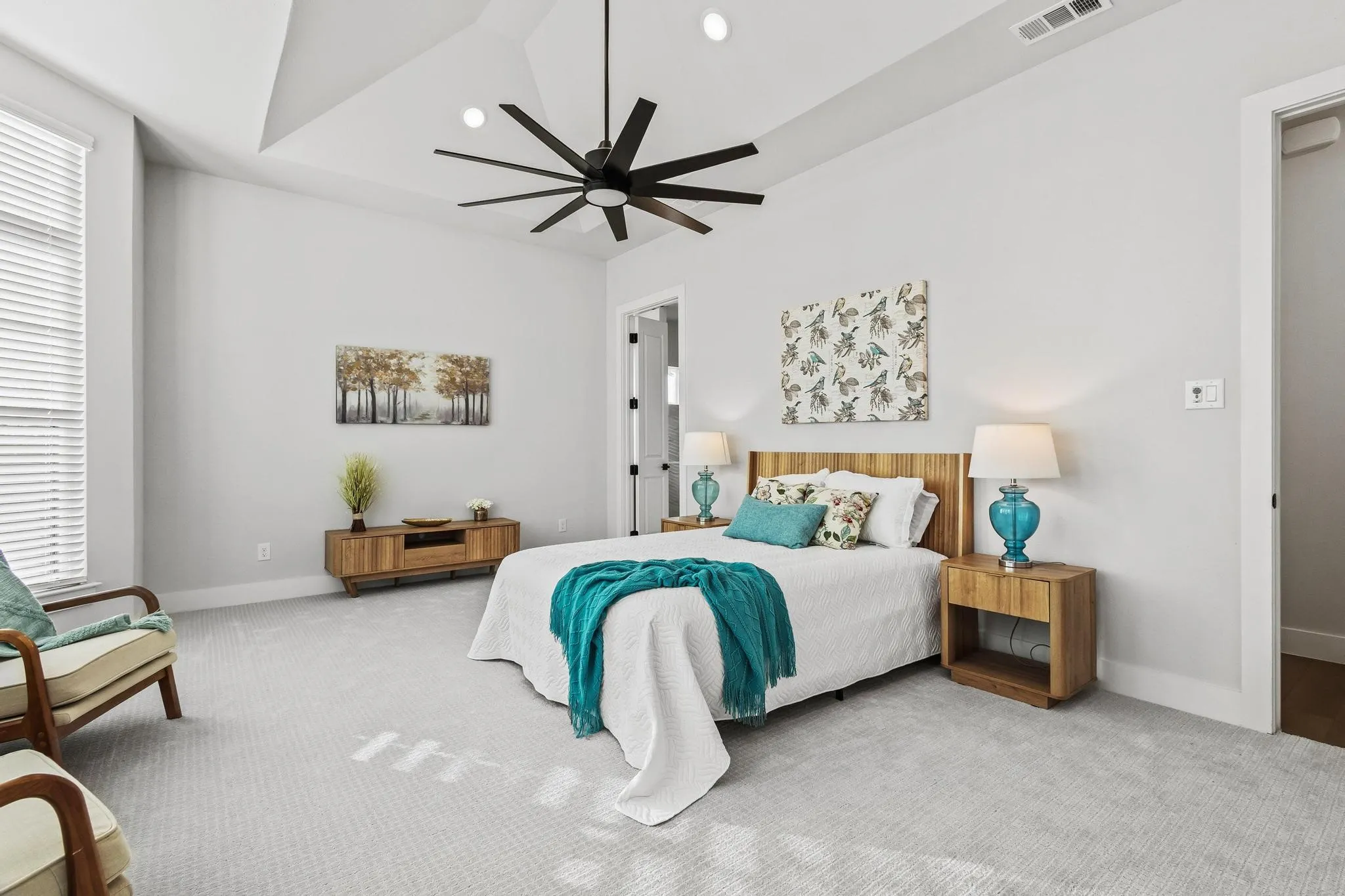 Primary bedroom with recessed lighting, a ceiling fan, ensuite bath