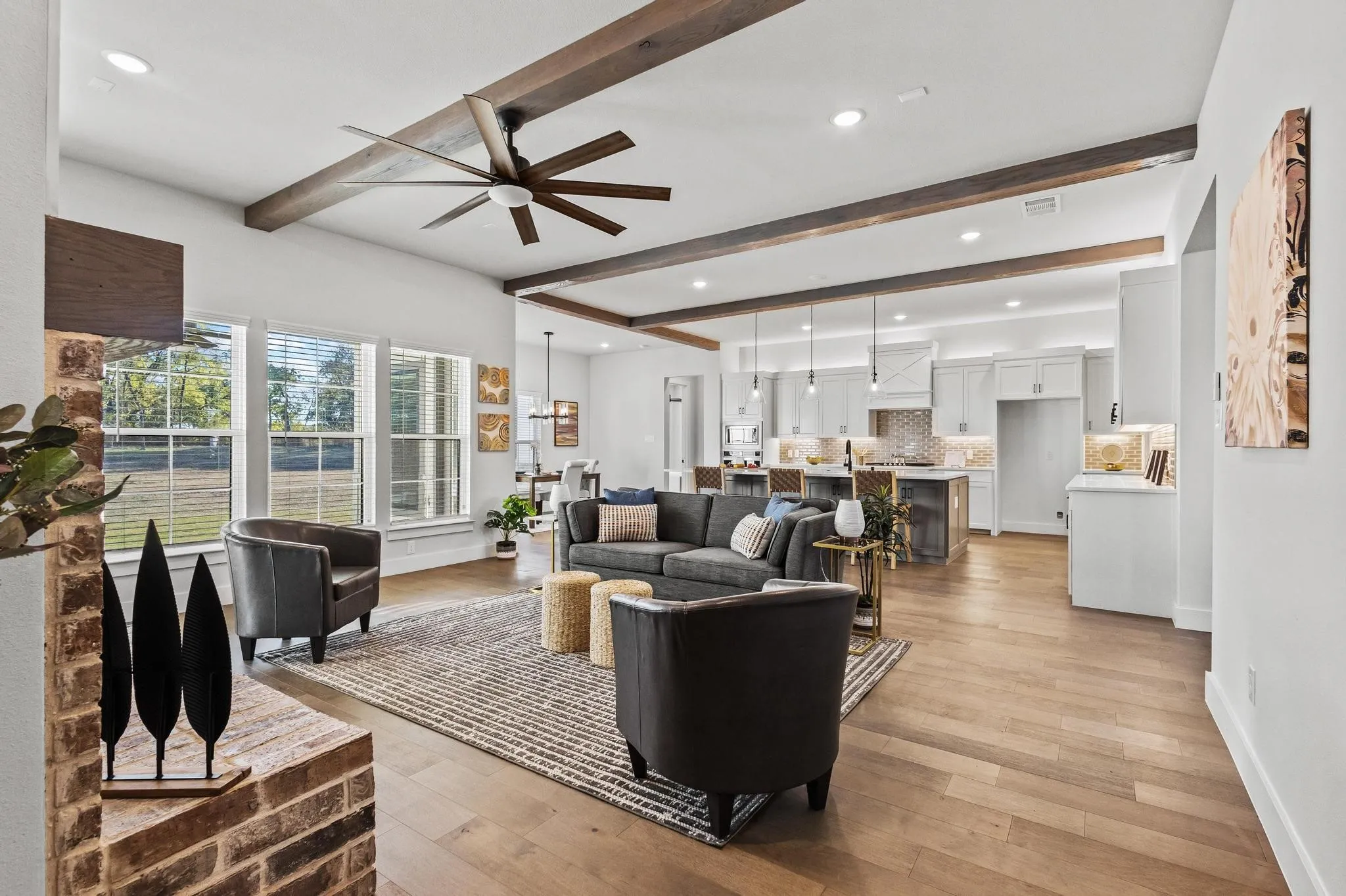 Living area featuring beam ceiling, light wood-type flooring, ceiling fan, and recessed lighting