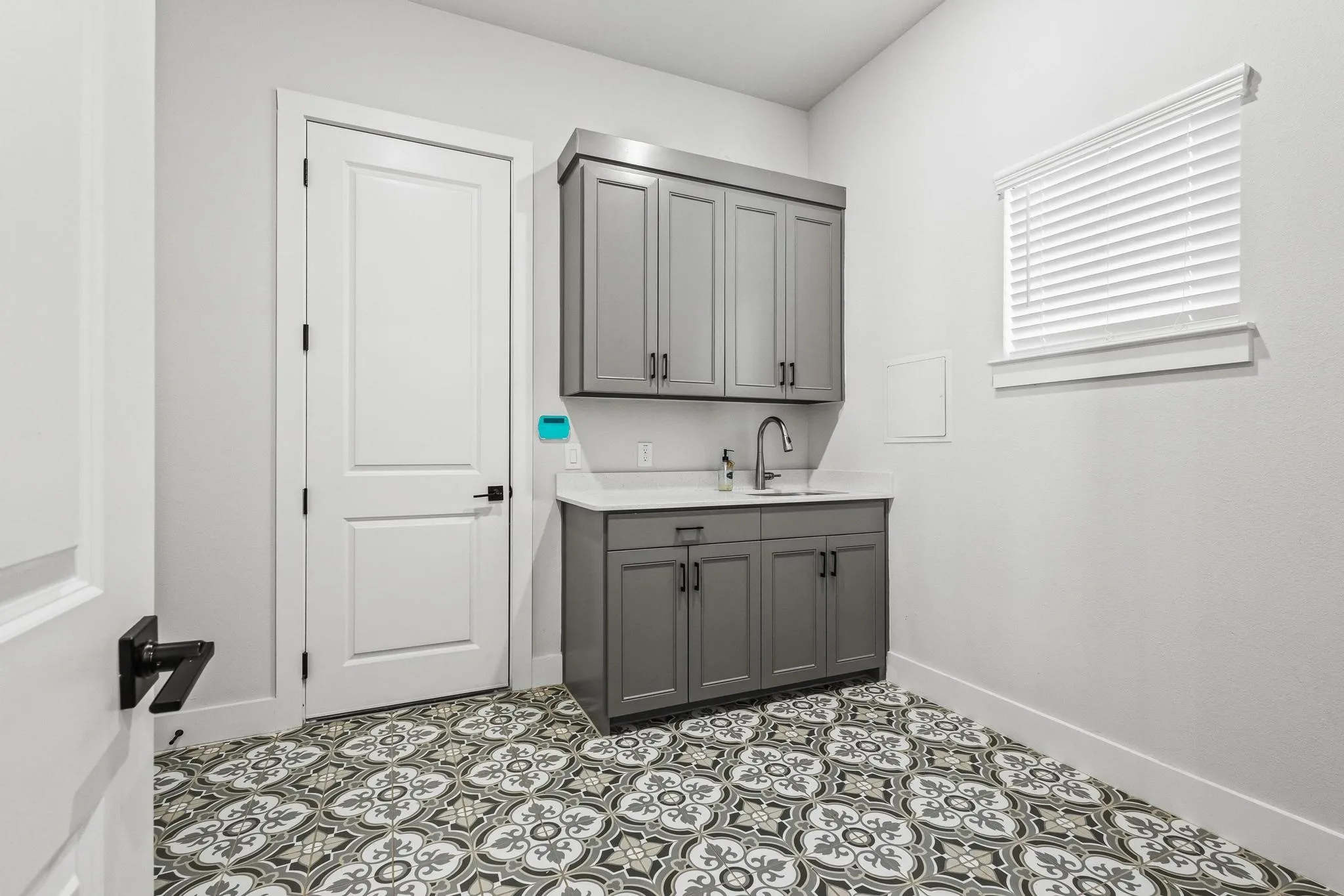 Laundry room featuring baseboards and light tile patterned flooring.  Plenty of storage!