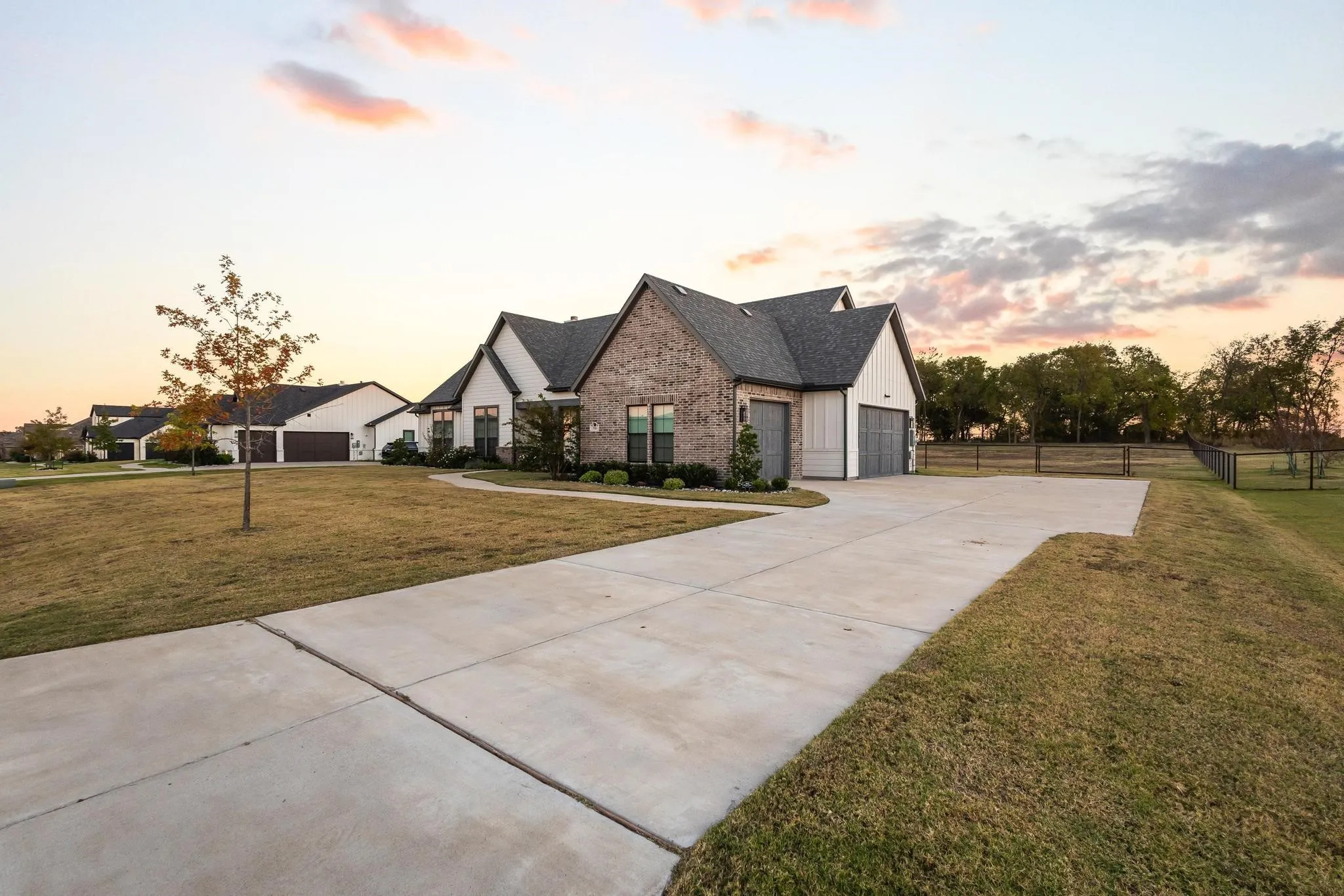 Modern farmhouse with board and batten siding and driveway