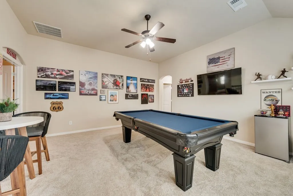 Recessed lighting, vaulted ceilings, and a ceiling fan with integrated lighting