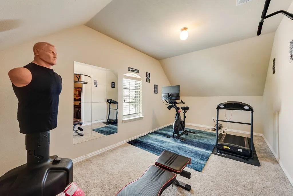 Room featuring sloped ceilings, carpeted flooring, a window with blinds, and recessed lighting