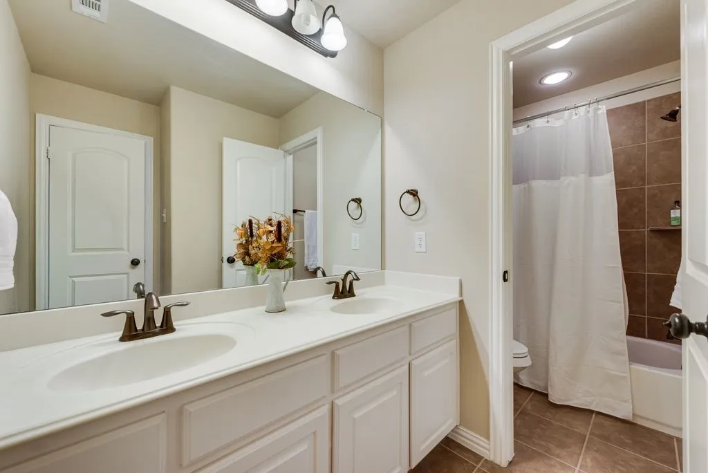 Double vanity with white cabinetry and integrated sinks