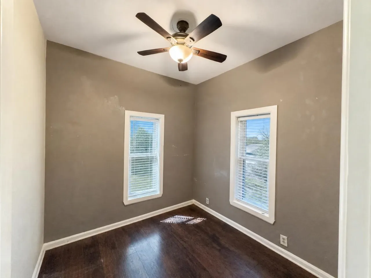 Dark wood-finish flooring with white trim