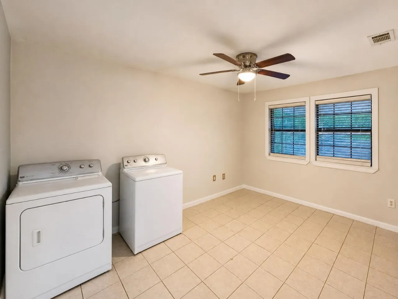 Ceiling fan, dual windows, tiled flooring, neutral wall color