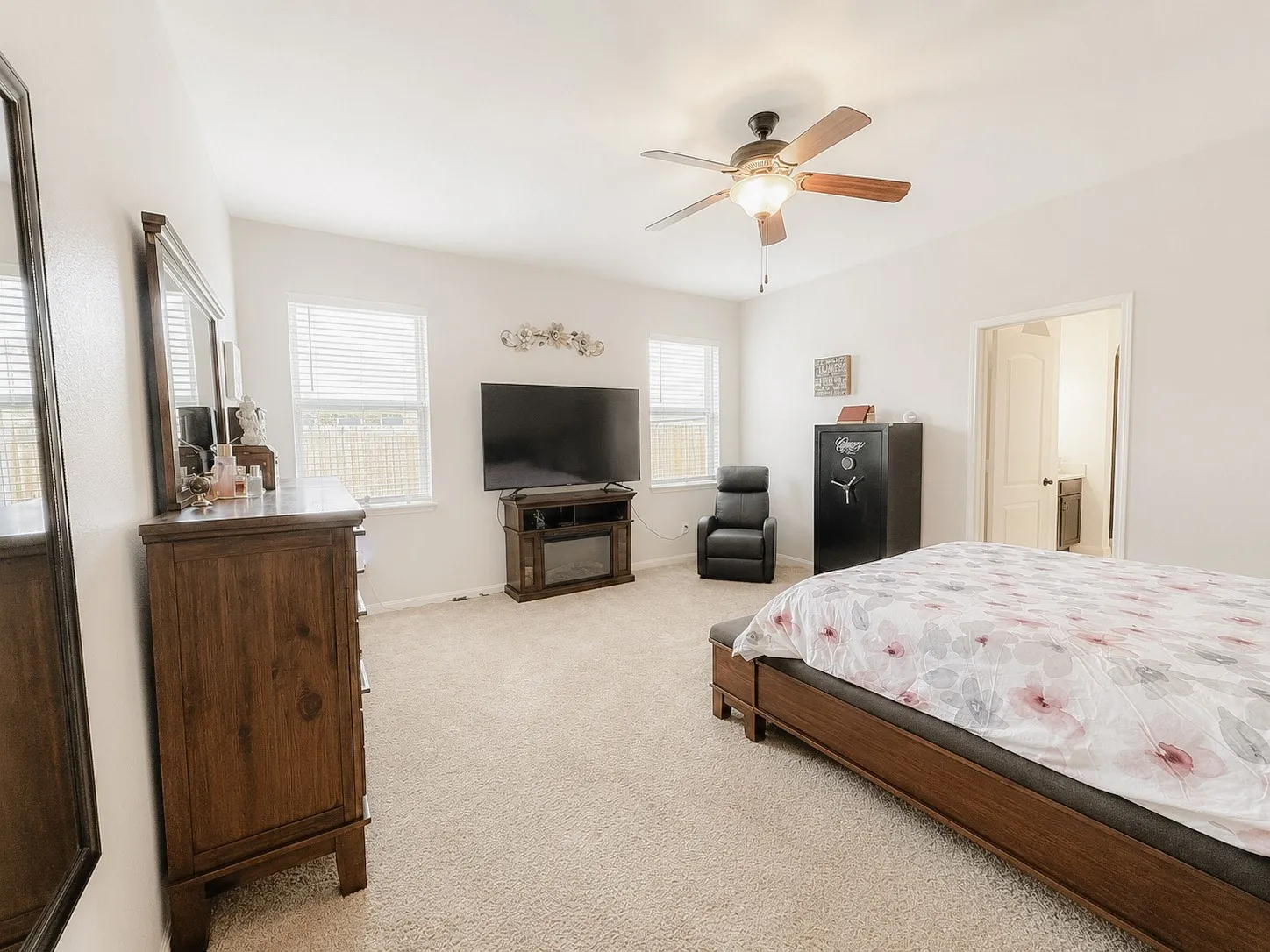 Recessed lighting, ceiling fan with light fixture, neutral carpeting, and multiple windows with blinds