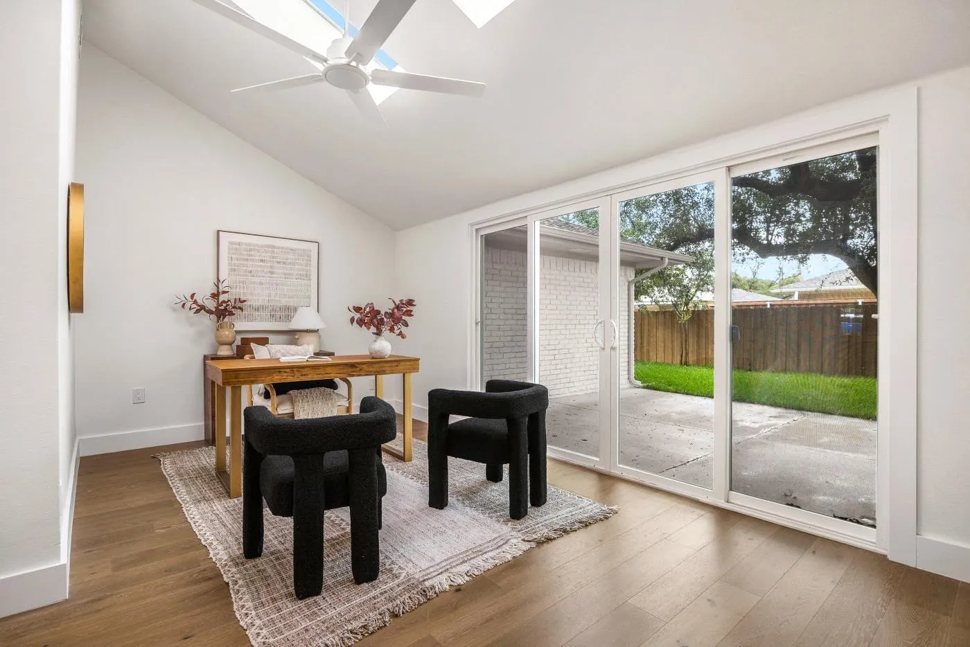 Sunroom with sliding glass doors out to backyard patio.