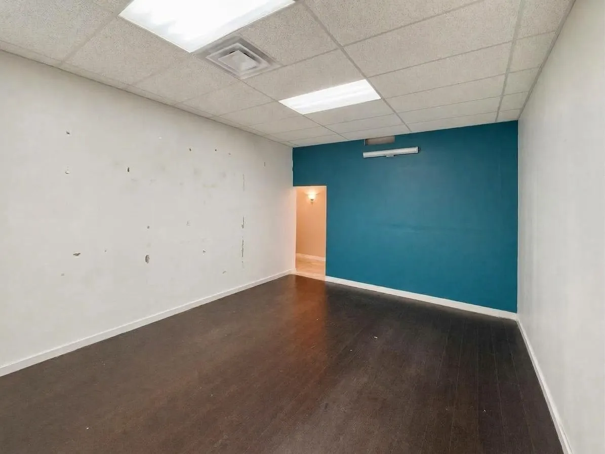 Recessed lighting, drop ceiling, wood-finish flooring, two-tone painted walls, and built-in wall lighting