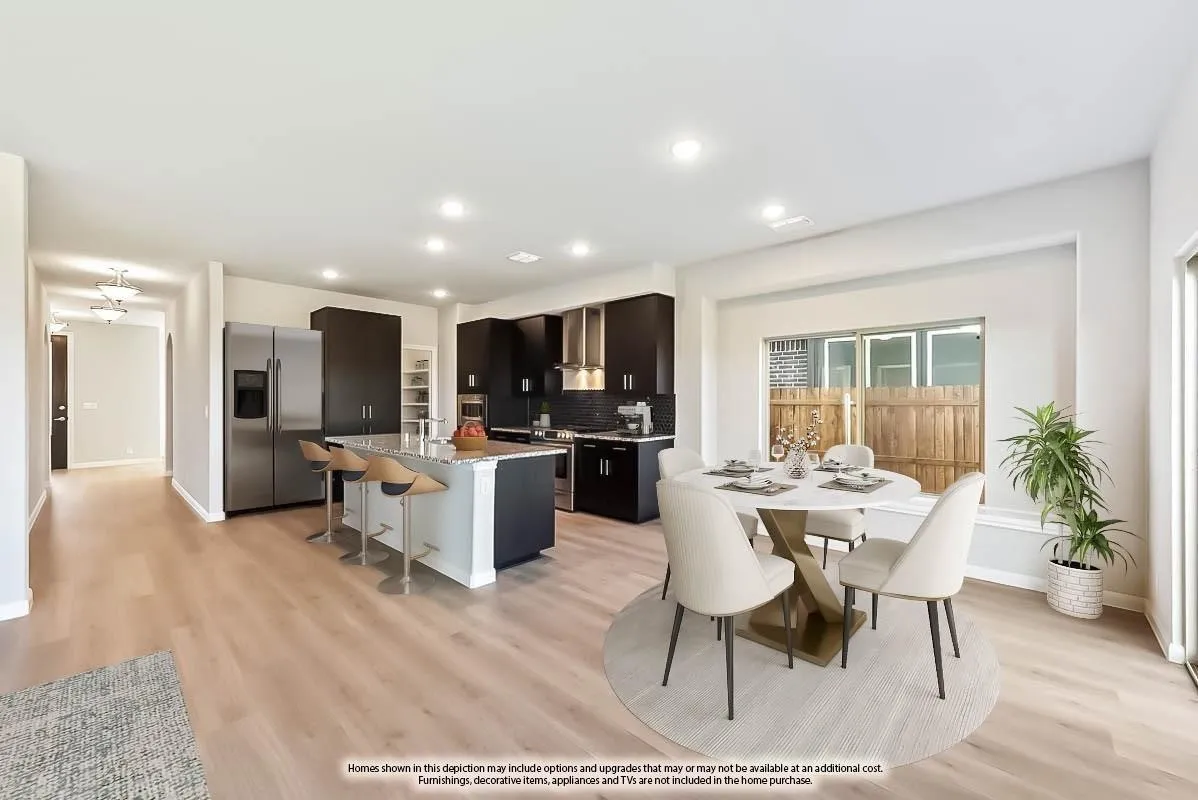Open-concept living space with wood-finish flooring