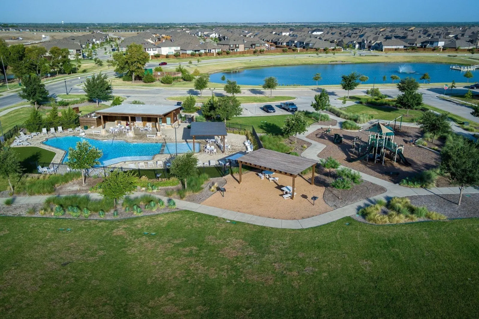 Community amenities featuring a swimming pool, covered outdoor seating, playground, and walking paths