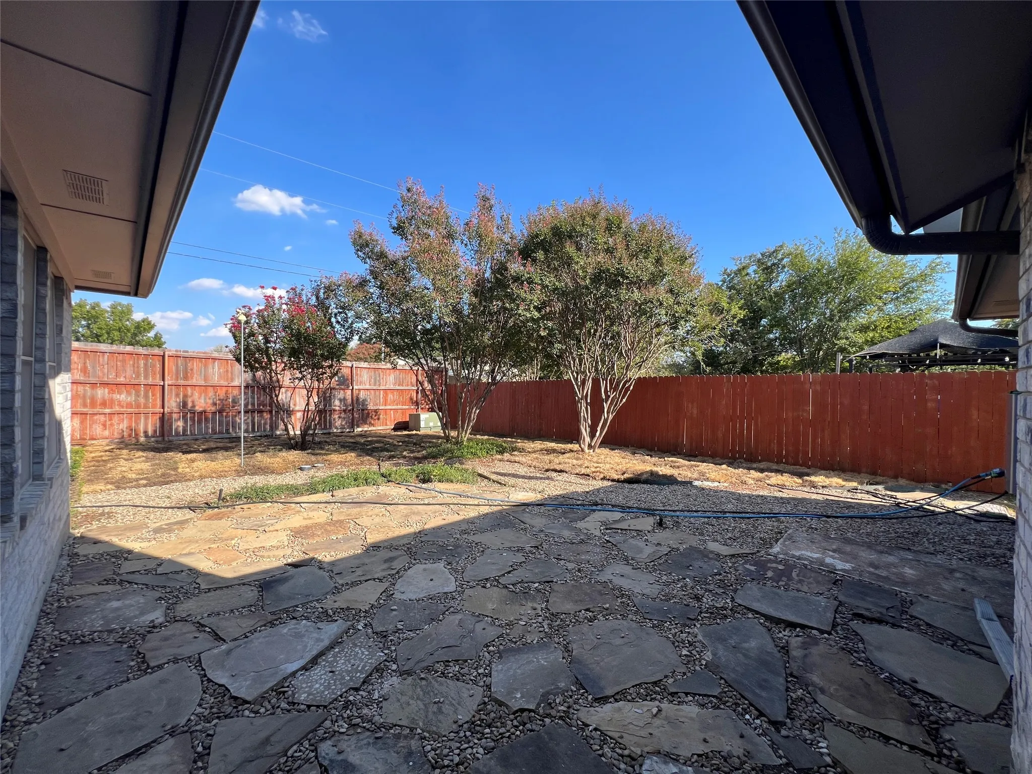 Patio area featuring flagstone paving and gravel infill