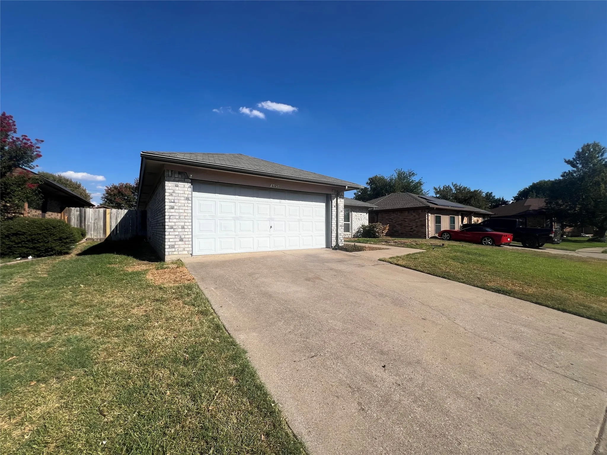Attached two-car garage with a concrete driveway