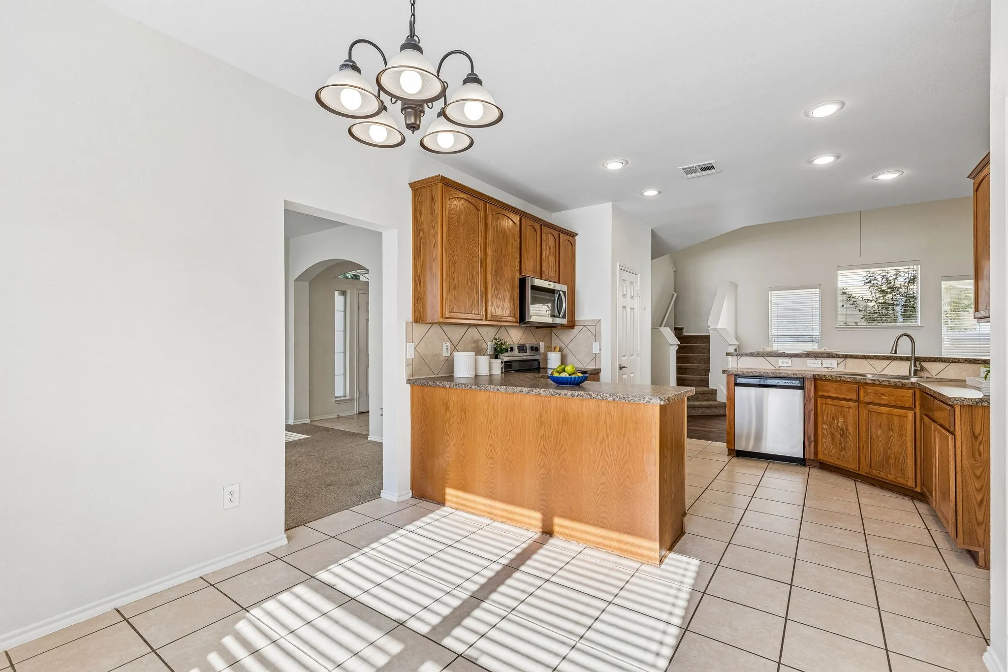 A peninsula with breakfast bar seating creates the perfect gathering space for casual meals and conversation.