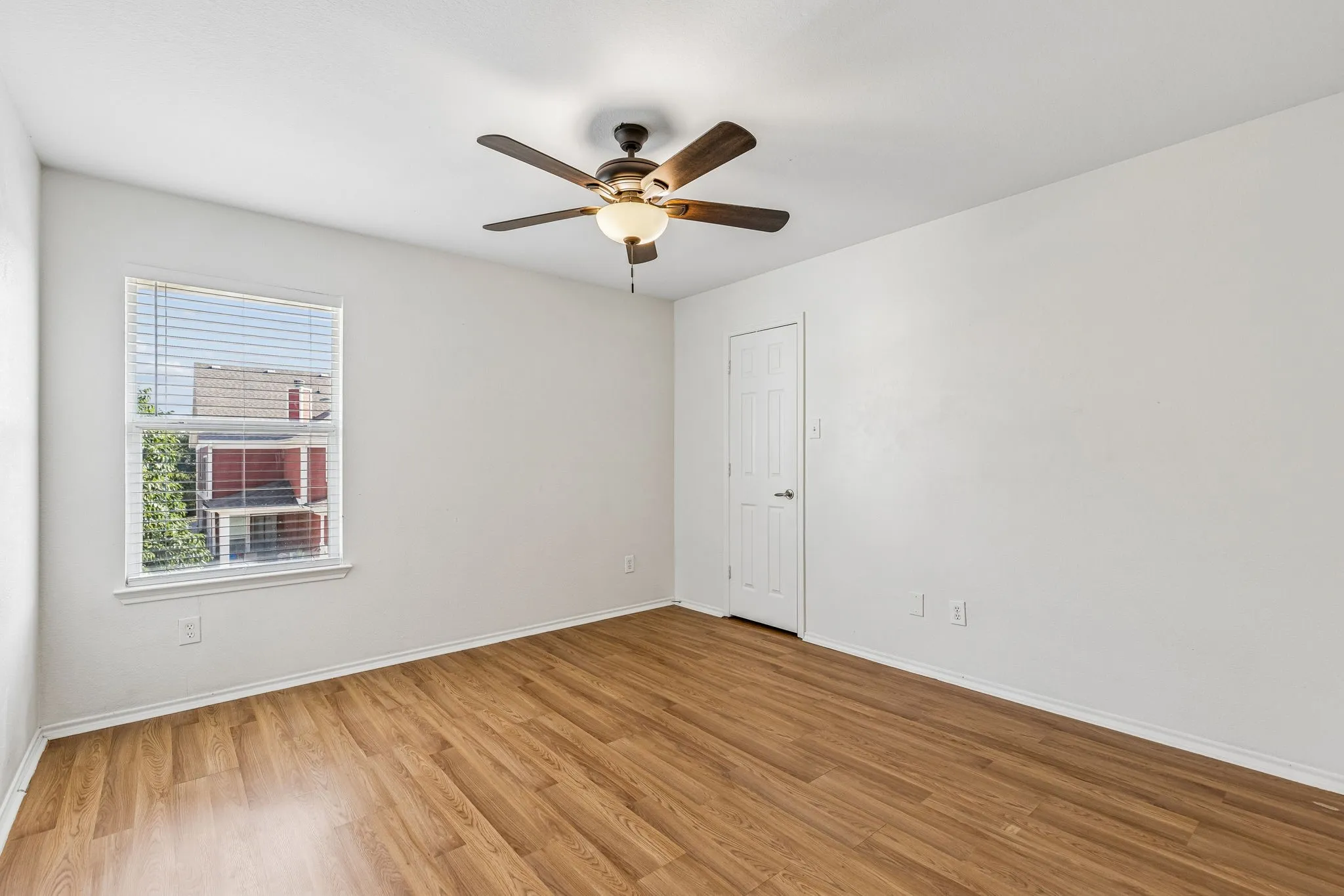 A spacious secondary bedroom offers abundant natural light and a generously sized walk-in closet.