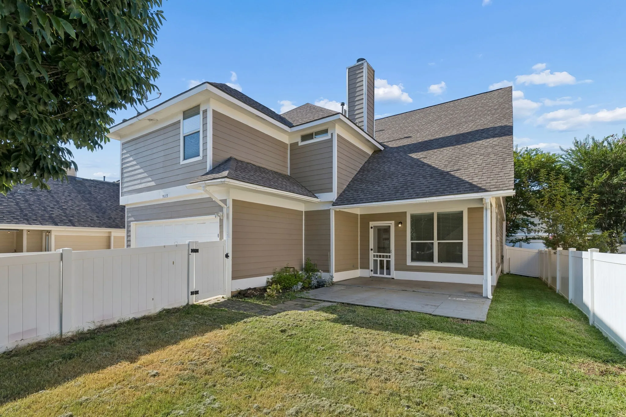 The private backyard offers a wonderful balance of green space and outdoor living areas to enjoy year-round.
