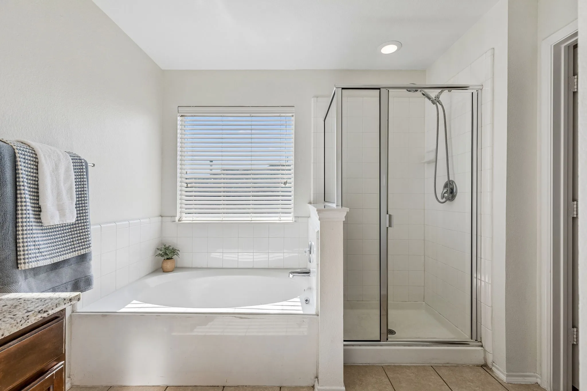 Unwind in the garden tub or enjoy the separate shower in this spacious primary bathroom.